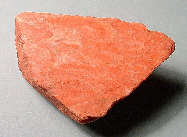 feldspar-orthoclase-pinkish orange cleavage fragment