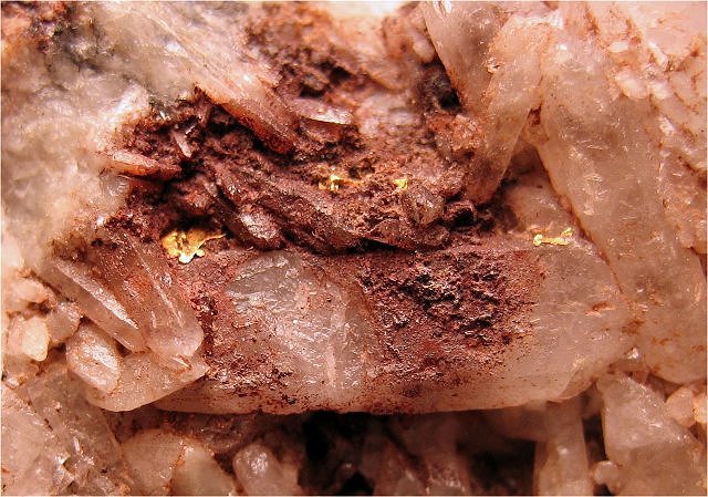 gold-small patches among quartz crystals