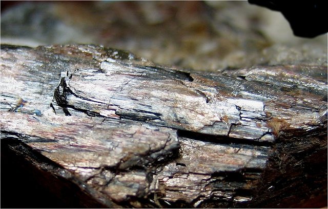 huebnerite-light brown elongated cleavage surfaces