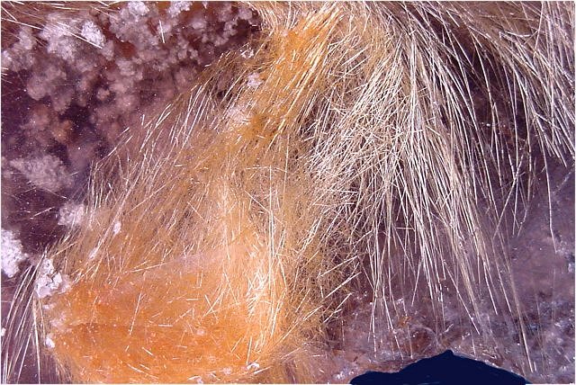 rutile-yellow and gray hair-like crystals embedded in clear quartz