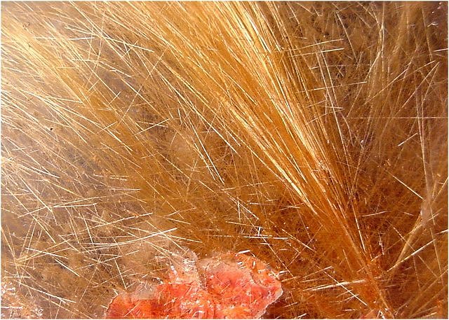 rutile-yellow hair-like crystals embedded in clear quartz