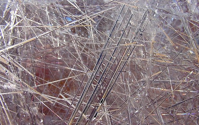 rutile-steel gray needle-like crystals embedded in quartz