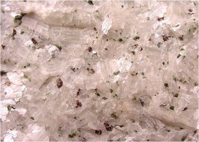 wollastonite white crystalline mass with dark garnets