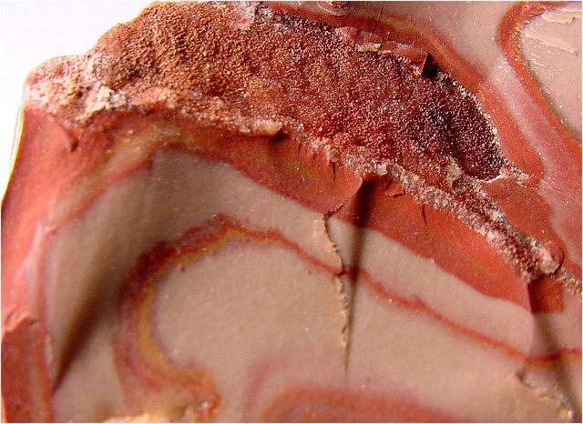 rhyolite (wonderstone) banded with dark pink light pink and yellow to orange layers